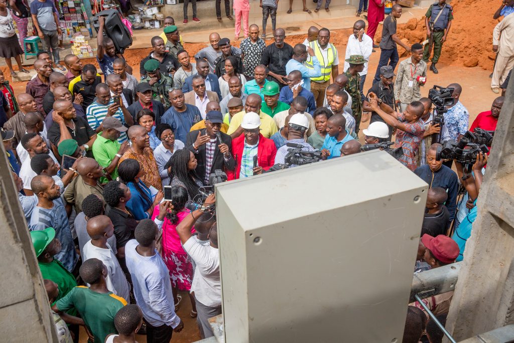 Hon. Minister of Power, Works & Housing, Mr Babatunde Fashola,SAN(middle) flanked by the Managing Director/CEO, Rural Electrification Agency(REA), Mrs Damilola Ogunbiyi (left) and others while addressing traders during the inspection of the electrified shops under the Federal Government 's Energizing Economies Initiative at Ariaria Market Aba, Abia State on Thursday, 17th May 2018.  