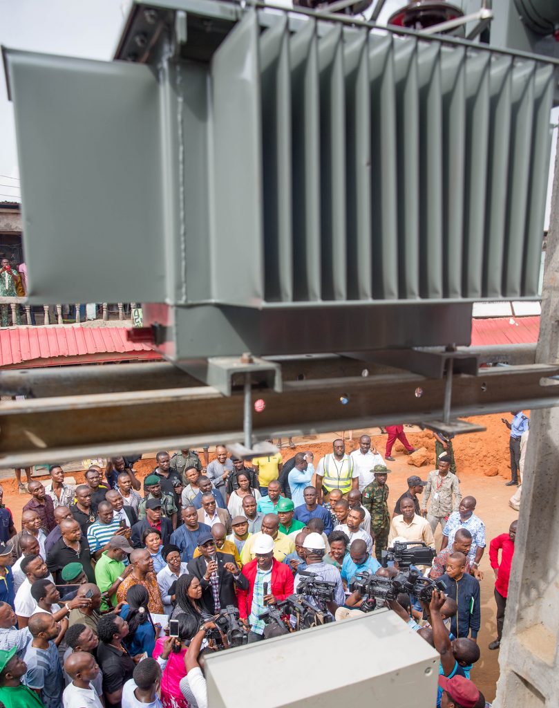 Hon. Minister of Power, Works & Housing, Mr Babatunde Fashola,SAN(middle) flanked by the Managing Director/CEO, Rural Electrification Agency(REA), Mrs Damilola Ogunbiyi (left) and others while addressing traders during the inspection of the electrified shops under the Federal Government 's Energizing Economies Initiative at Ariaria Market Aba, Abia State on Thursday, 17th May 2018. 