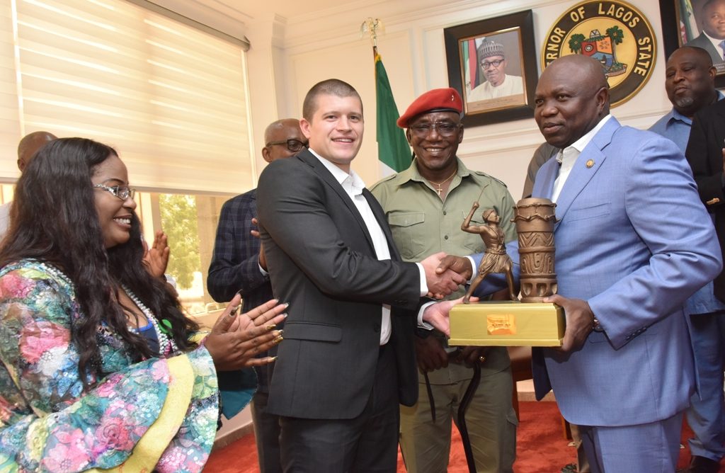 Lagos State Governor, Mr. Akinwunmi Ambode (right), presents a souvenir to Manager, World Para Powerlifting Competition, Mr. Sam Munkley (2nd left) while Minister of Youth and Sports, Mr. Solomon Dalung (2nd right) and President, Nigeria Para-Powerlifting Federation, Mrs. Queen Ubah (left), watch with admiration during a courtesy visit by the Sports Minster and delegation from the International Paralympics Committee at Lagos House, Alausa, Ikeja, on Thursday, June 7, 2018.  