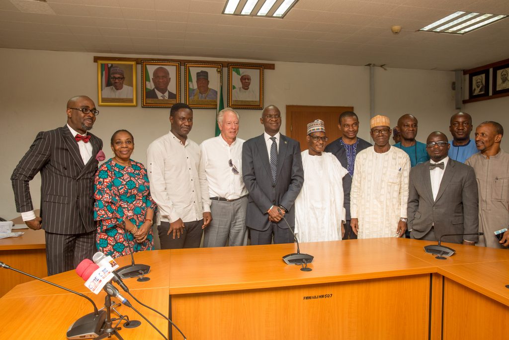 Hon. Minister of Power, Works & Housing, Mr Babatunde Fashola, SAN(3rd right), Permanent Secretary Works & Housing, Mr Mohammed Bukar(middle), Director Human Resource, Mrs Morayo Alimi(2nd left),former Assistant Technical Adviser of the Super Eagles, Bonfrere Jo (4th left), Legal Consultant to Mr Jo, Mr Obasanjo Lawal Esq. (left) , former Super Eagles player, Benedict Akwuegbu (3rd left), Director Public Buildings and Housing Development, Mr Dickson Onoja (3rd right) and others in a group photograph shortly after the handing over of the keys of the Federal Government allocated House to the Coach in fulfillment of Government's Pledge 24 years ago for Winning the 1994 African Cup of Nations at the Ministry of Power,Works & Housing Headquarters, Mabushi, Abuja on Tuesday 5th, June 2018. 