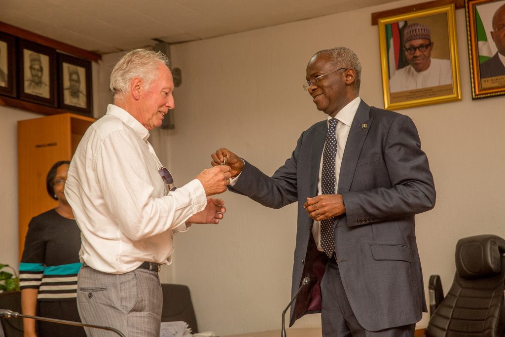 Hon. Minister of Power, Works & Housing, Mr Babatunde Fashola, SAN (right) handing over the keys of the Federal Government allocated House to former Assistant Technical Adviser of the Super Eagles, Bonfrere Jo(left) in fulfillment of Government's Pledge 24 years ago for Winning the 1994 African Cup of Nations at the Ministry of Power,Works & Housing Headquarters, Mabushi, Abuja on Tuesday 5th, June 2018. 