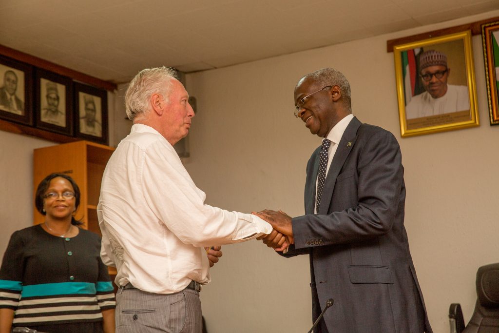 Hon. Minister of Power, Works & Housing, Mr Babatunde Fashola, SAN (right) congratulating former Assistant Technical Adviser of the Super Eagles, Bonfrere Jo(left) shortly after handing over the keys of the Federal Government allocated House to him in fulfillment of Government's Pledge 24 years ago for Winning the 1994 African Cup of Nations at the Ministry of Power,Works & Housing Headquarters, Mabushi, Abuja on Tuesday 5th, June 2018. 