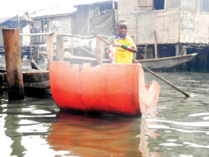 Photo of the Day!BOY PADDLING TO SCHOOL AT MAKOKO